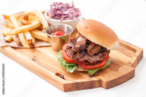 beef burger with mushrooms and onions and french fries photo