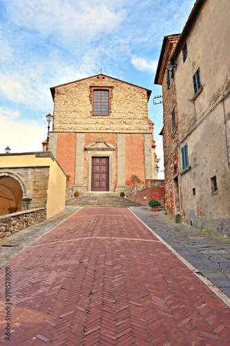 external facade of the collegiate church of San Michele Arcangelo located in the medieval Tuscan village of Lucignano in Arezzo, Italy © Simona Bottone