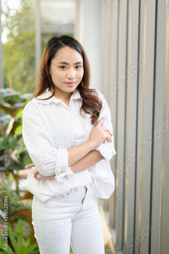 Portrait of confident business asian woman wearing white shirt in office Free Download Portrait of confident business asian woman wearing white shirt in office - GFXLoad