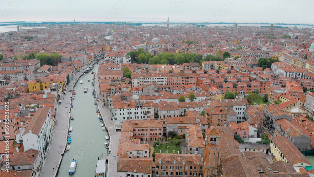 Obraz premium aerial view of Venice in daytime, drone is flying over amazing italian city, red roofs and canal