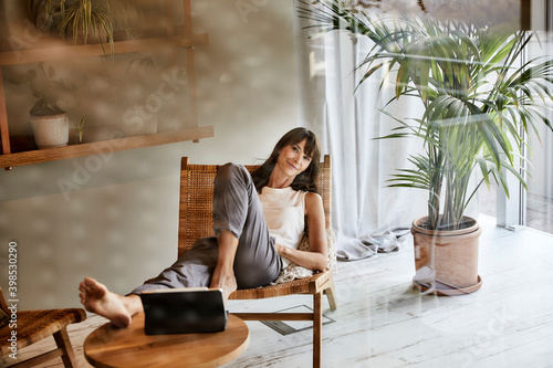 Woman resting while sitting on chair at home