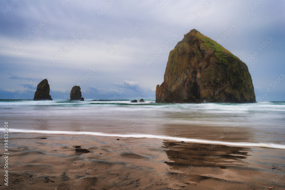 Cannon Beach Haystack Rock and Needles under cloudy skies
