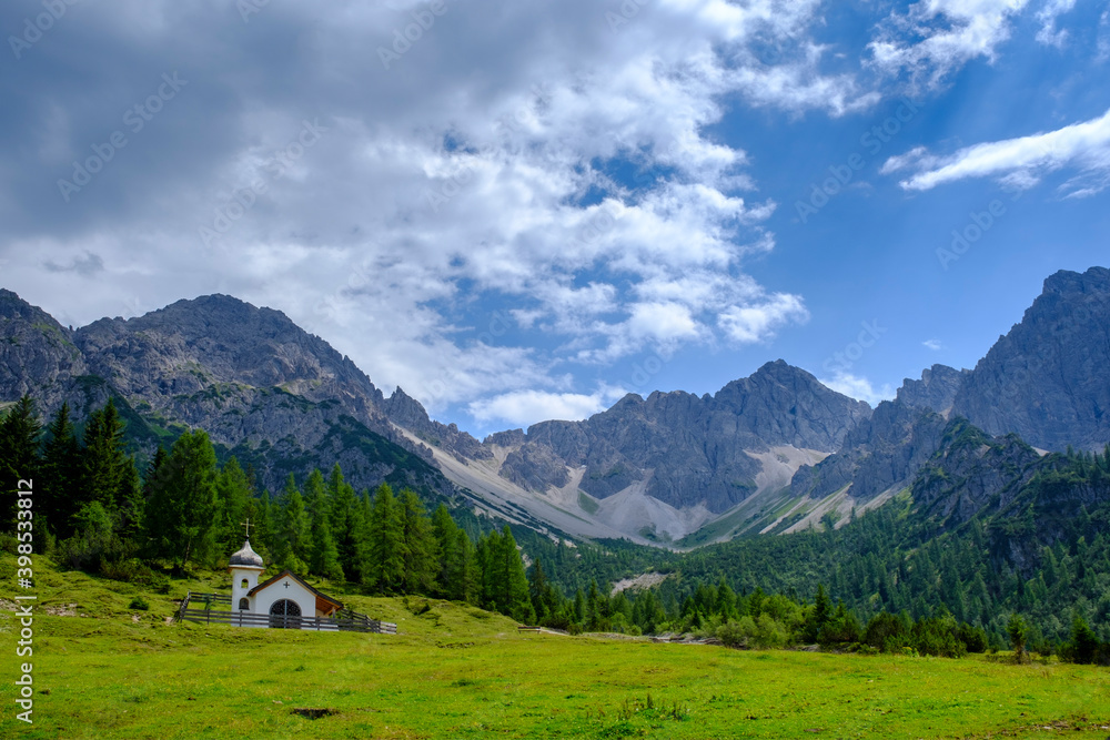Scenic view of lone chapel in Karwendel mountains during summer Scenic view of lone chapel in Karwendel mountains during summer