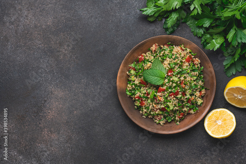Quinoa salad with parsley, cucumber and cherry tomatoes. Tabbouleh Traditional middle eastern or arab dish photo