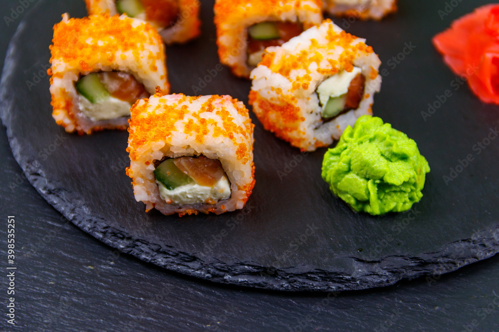 Sushi rolls Philadelphia on a black slate Sushi rolls Philadelphia on a black slate