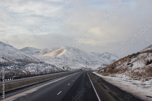 Wallpaper Mural Highway in the middle of the mountains in a snowy winter. A beautiful asphalt road among the snow-covered mountains. Oregon, USA Torontodigital.ca