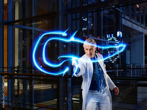Male internist light painting pancreas in laboratory at hospital