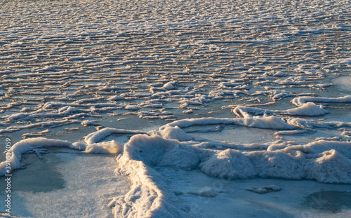 snow-covered seashore.Winter sunset on the sea.