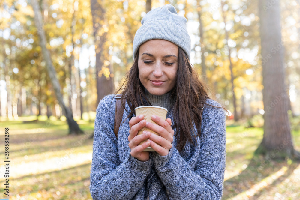 Female hiker holding tea cup in Cannock Chase woodland during winter Female hiker holding tea cup in Cannock Chase woodland during winter