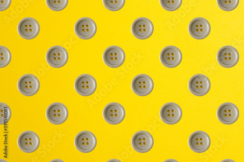 Plastic buttons isolated on yellow. Plastic buttons pattern.