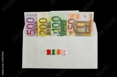 different euro banknotes in an envelope on a black background. Financial concept. The concept of economic crisis and income risk. Top view. photo