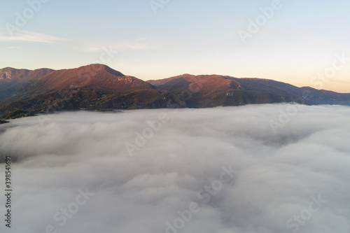 Flying through the clouds at dawn above the jumping lake in Rieti © Claudio Quacquarelli