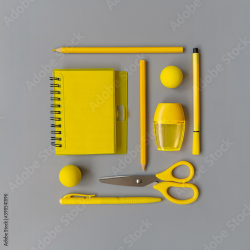 Yellow stationery square on gray. Flat lay, color 2021.