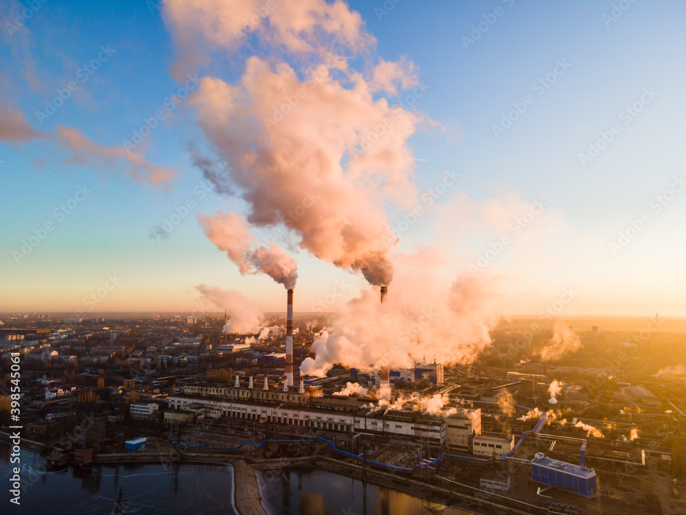 Aerial view of high smoke stack with smoke emission. Plant pipes pollute atmosphere. Industrial factory pollution, smokestack exhaust gases. Industry zone, thick smoke plumes. Climate change, ecology Aerial view of high smoke stack with smoke emission. Plant pipes pollute atmosphere. Industrial factory pollution, smokestack exhaust gases. Industry zone, thick smoke plumes. Climate change, ecology