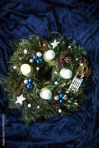Christmas decoration on a blue background. Top view on an white blue advent wreath.