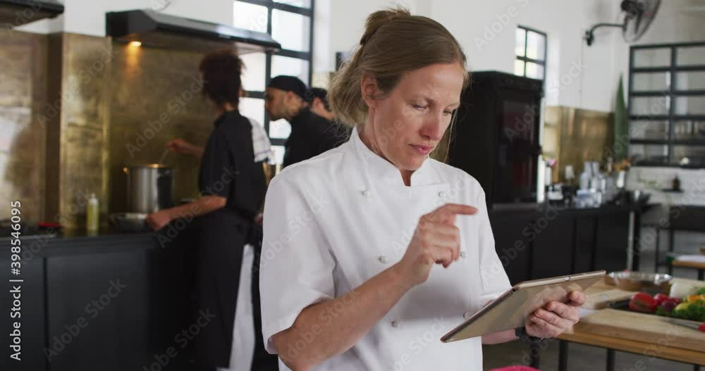Caucasian female chef teaching diverse group Caucasian female chef teaching diverse group