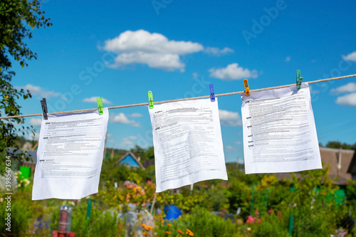 The documents tax forms were washed and dried in the open air by hanging from a clothesline. Concepts of money laundering, legalization of income, concealment of income, tax evasion photo