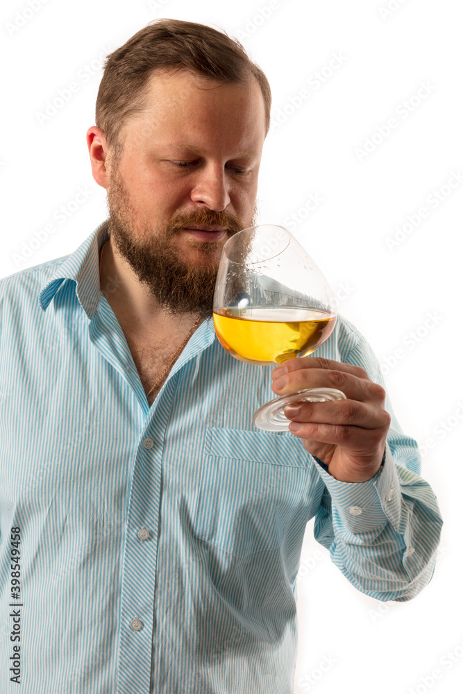 Solid bearded man in shirt tasting whisky studio portrait Solid bearded man in shirt tasting whisky studio portrait