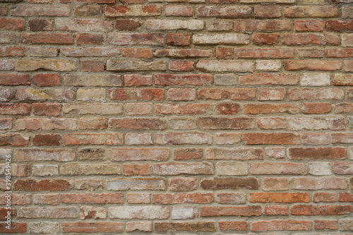 Seamless brick wall with red, grey and brown stones, stone wall background with space for text and no person 