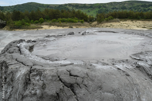 Bubbling crater of a mud volcano. Close up view onto gas bubble exploding in crater of mud volcano. Mud volcano at Paclele Mari, near Buzau, Romania.