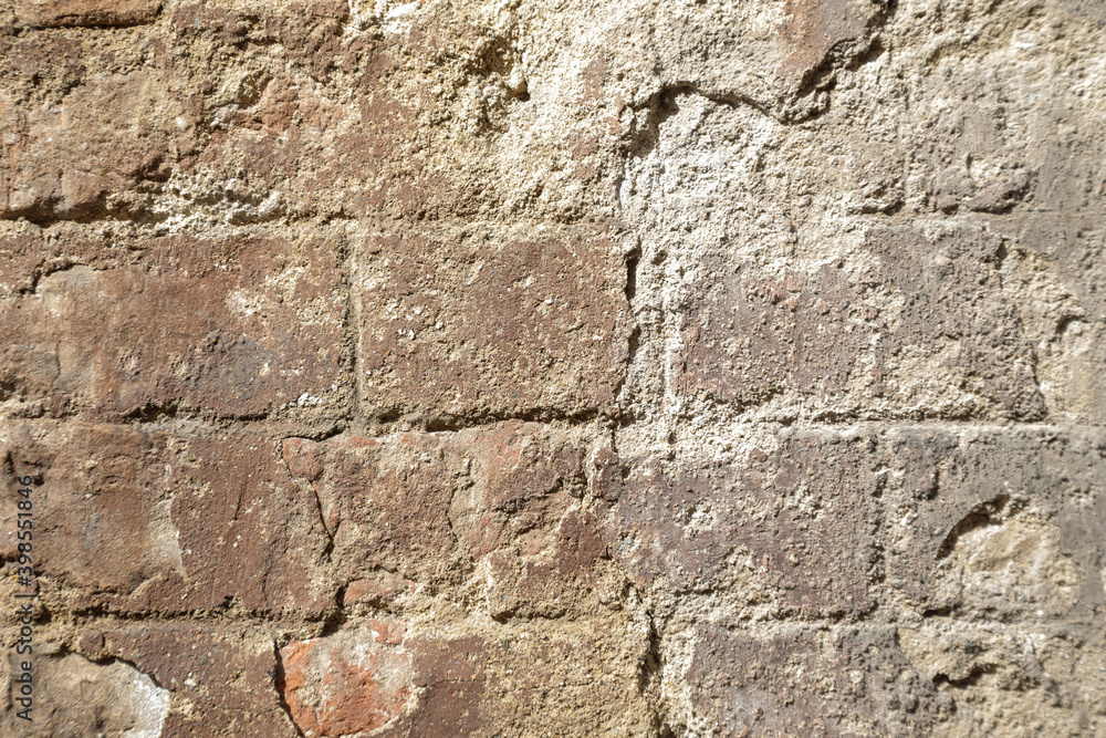 Cracked concrete brick wall with structure stones, rustic stones background with space for text Cracked concrete brick wall with structure stones, rustic stones background with space for text