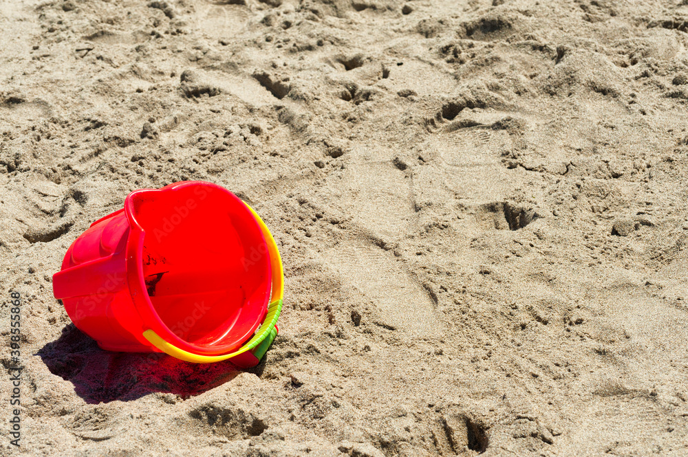Copyspace of red bucket in the sand Copyspace of red bucket in the sand
