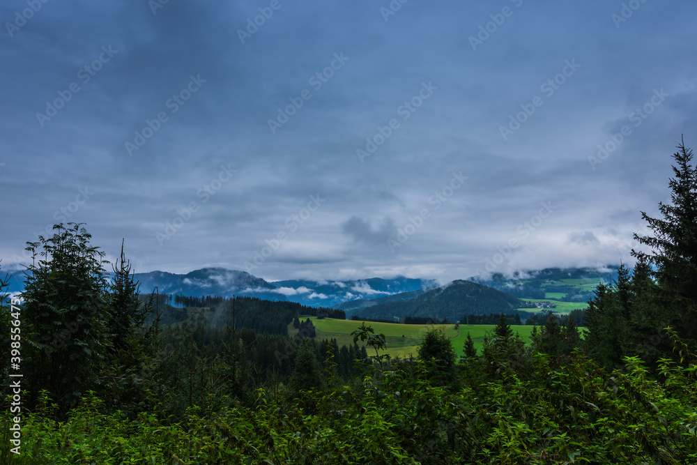 green nature landscape with rain clouds and fog green nature landscape with rain clouds and fog