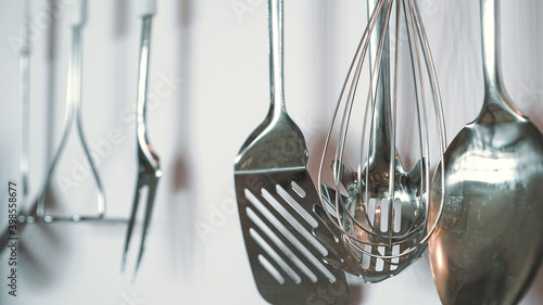Obraz na plátně Set of metal kitchen utensils hanging on wall.
