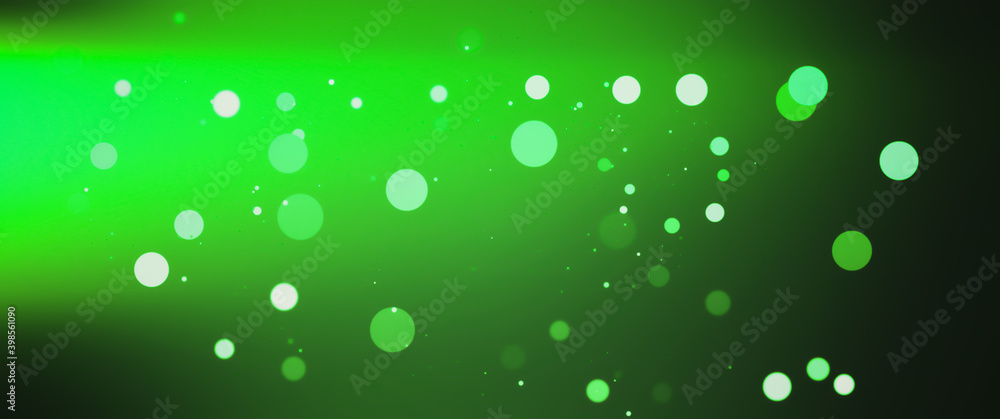 Blurred Green bokeh background with copy space. Abstract luxury glitter effect boke. Sparkling magical dust particles. Magic concept, defocused .