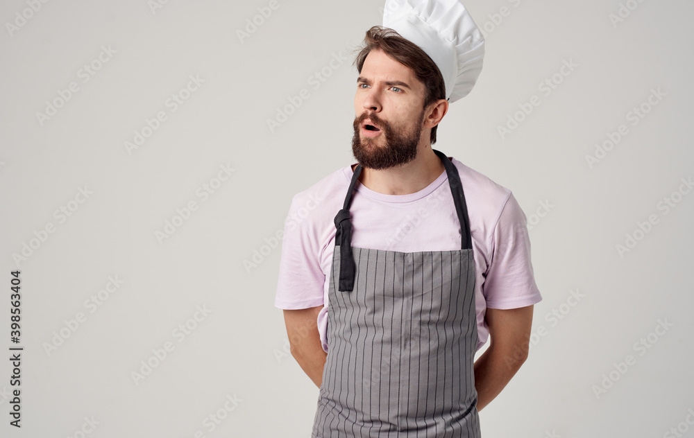 a professional chef in a headdress and an apron gestures with his hands a professional chef in a headdress and an apron gestures with his hands