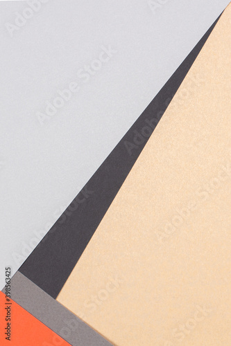 Geometric paper background. Orange  light gray  black and brown craft paper flat lay. Top view