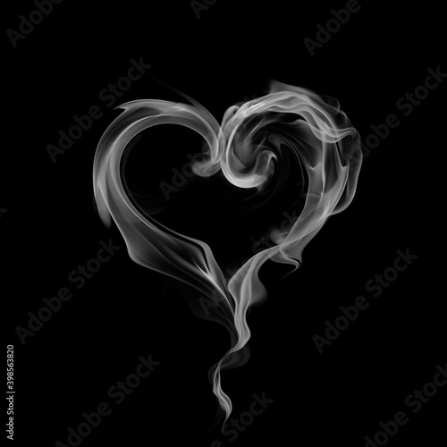 Heart symbol made of smoke isolated on black background © -Misha
