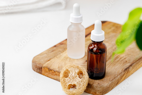 Glass cosmetic oil bottles with pipette in bathroom