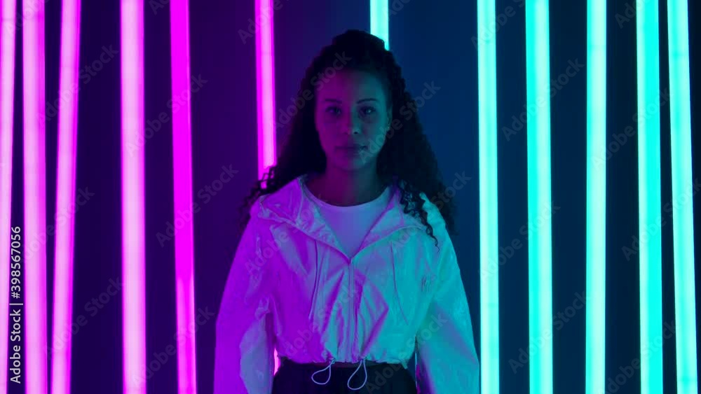 Portrait of a young lovely female African American looking at the camera. Slow motion.