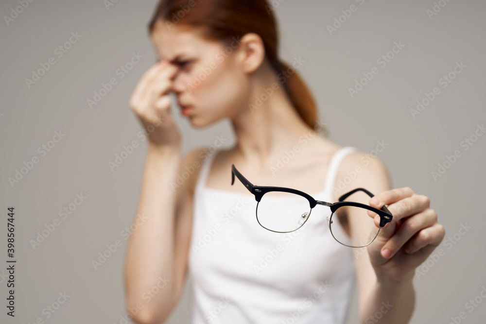woman in white t-shirt glasses vision problems myopia woman in white t-shirt glasses vision problems myopia