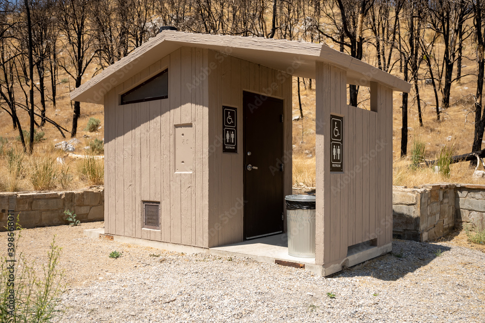Foto de Pit Toilet Stands at the Base of a Charred Forest do Stock Adobe Stock