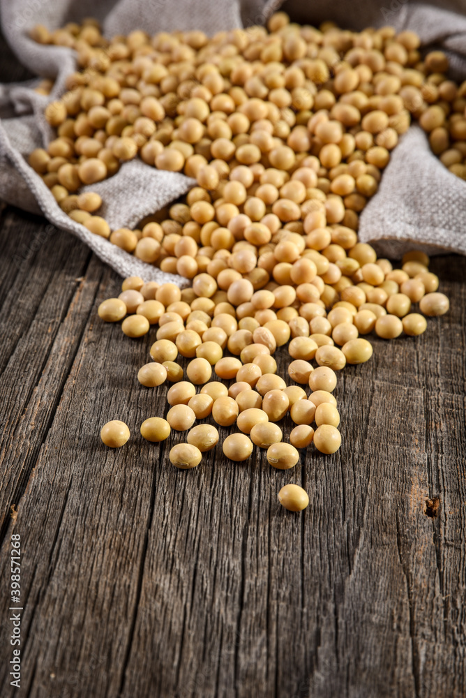 Close-up of soybean on wood background in jute sack. Close-up of soybean on wood background in jute sack.