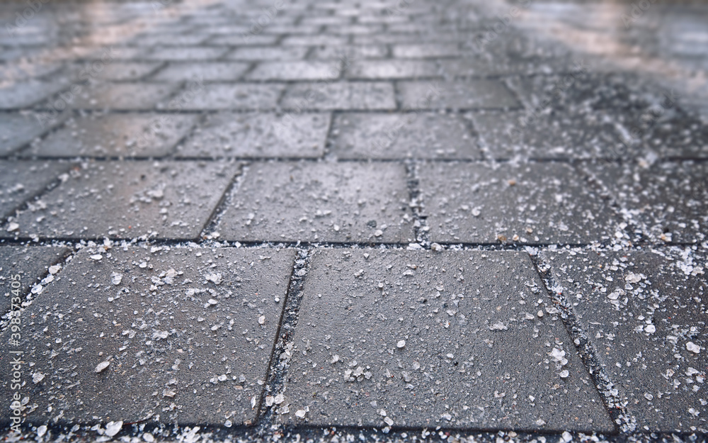Rock salt (sodium chloride) used on paving slabs and asphalt roads for