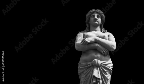 Goddess Aphrodite (Venus). Fragment of ancient statue isolated on black background. Copy space for design or text.