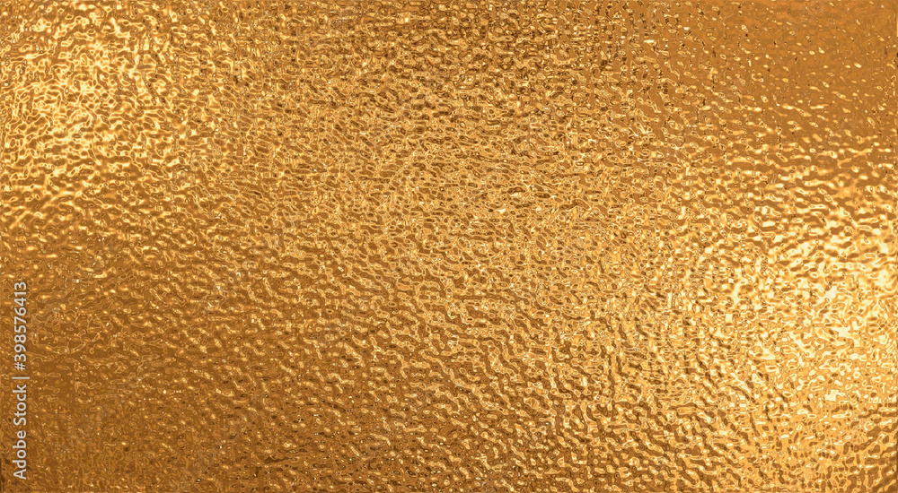 Naklejka premium Rough golden metallic film, abstract background.
