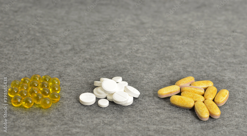 Health. Close-up of a tablet with clear capsules or soft gel capsules with omega-3 and vitamins c and d as a cure for immunity during the global covid-19 coronavirus pandemic and quarantine Health. Close-up of a tablet with clear capsules or soft gel capsules with omega-3 and vitamins c and d as a cure for immunity during the global covid-19 coronavirus pandemic and quarantine