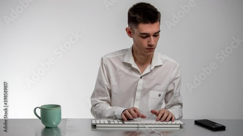 Busy businessman using keyboard and answering phone