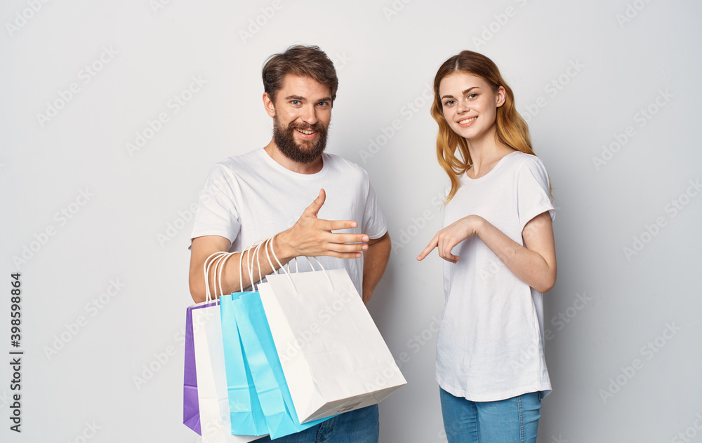 young couple with bags in their hands Shopping fun young couple with bags in their hands Shopping fun