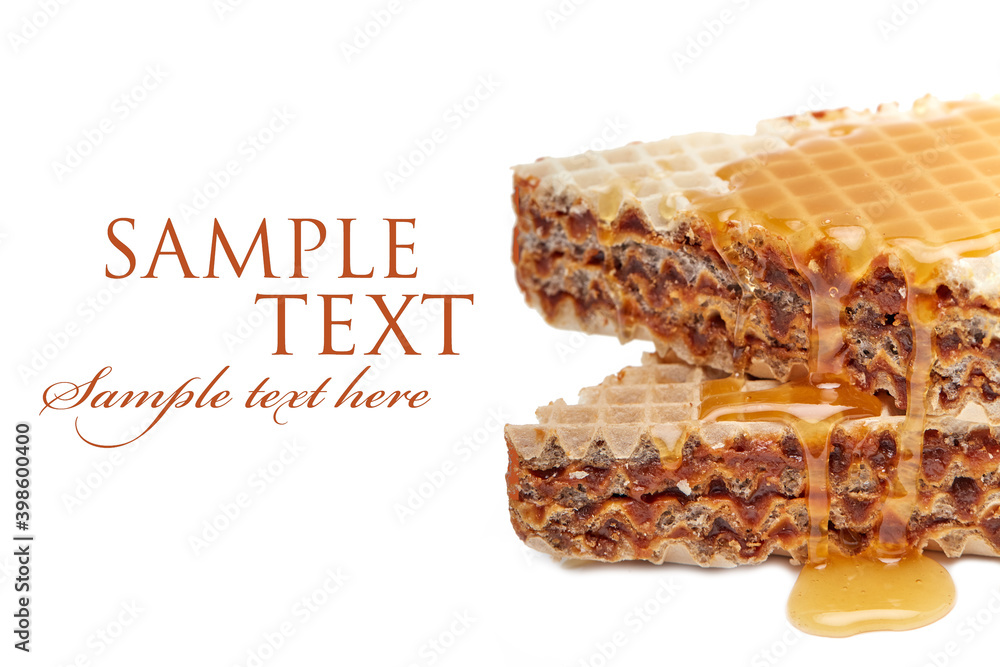 homemade freshly baked waffle cake on a white plate topped with honey on an isolated white background homemade freshly baked waffle cake on a white plate topped with honey on an isolated white background