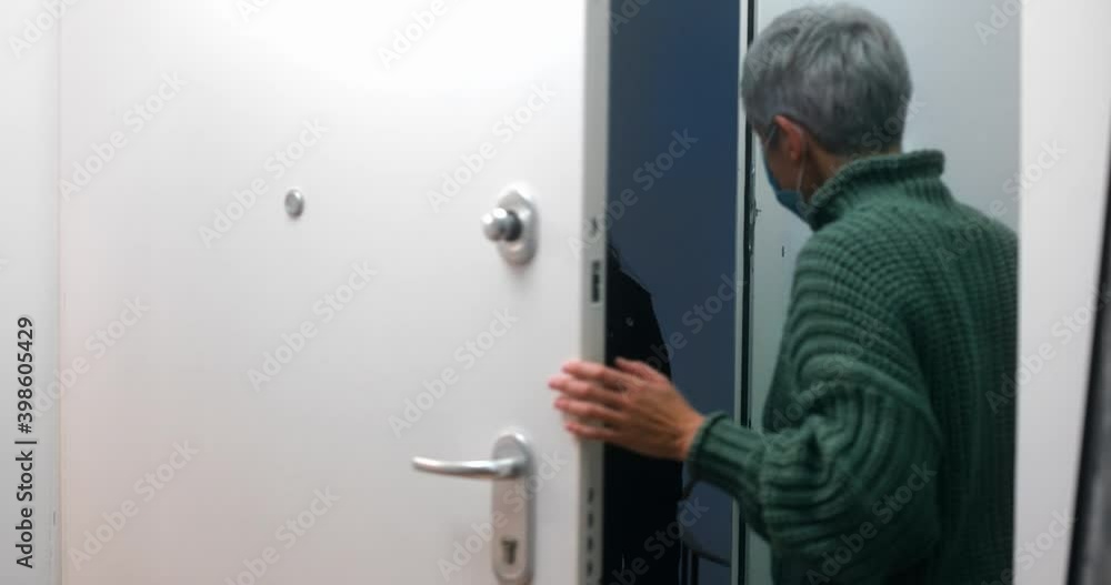 Senior woman receiving food delivery at home during covid quarantine