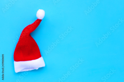 A santa hat on blue background. Copy space