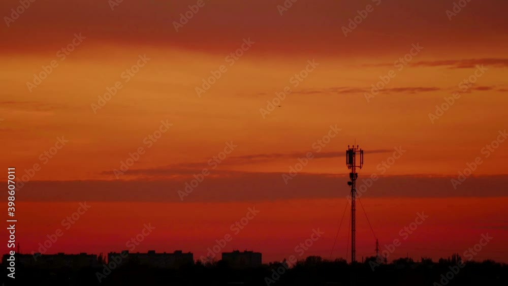 Cell tower time lapse. Orange sunset over the city. Cell tower time lapse. Orange sunset over the city.
