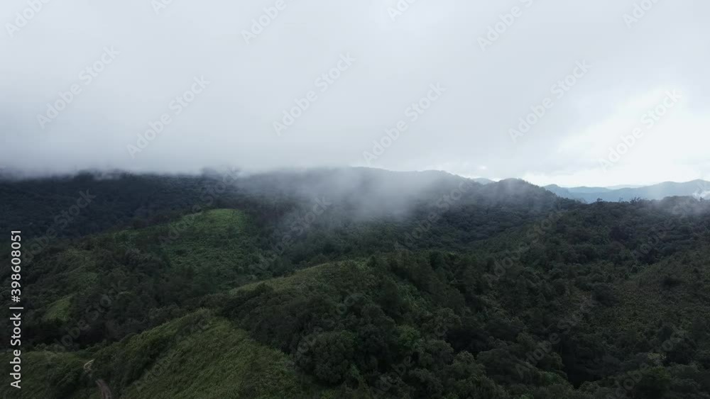 Drone Aerial view landscape beautiful nature of mountain range with forest in morning cloudy day. Panoramic green forest with wind blowing misty sea of fog passing mountain peak in Chiang Mai Thailand Drone Aerial view landscape beautiful nature of mountain range with forest in morning cloudy day. Panoramic green forest with wind blowing misty sea of fog passing mountain peak in Chiang Mai Thailand