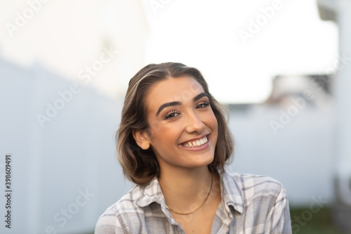 Smiling happy young woman in backyard 0288