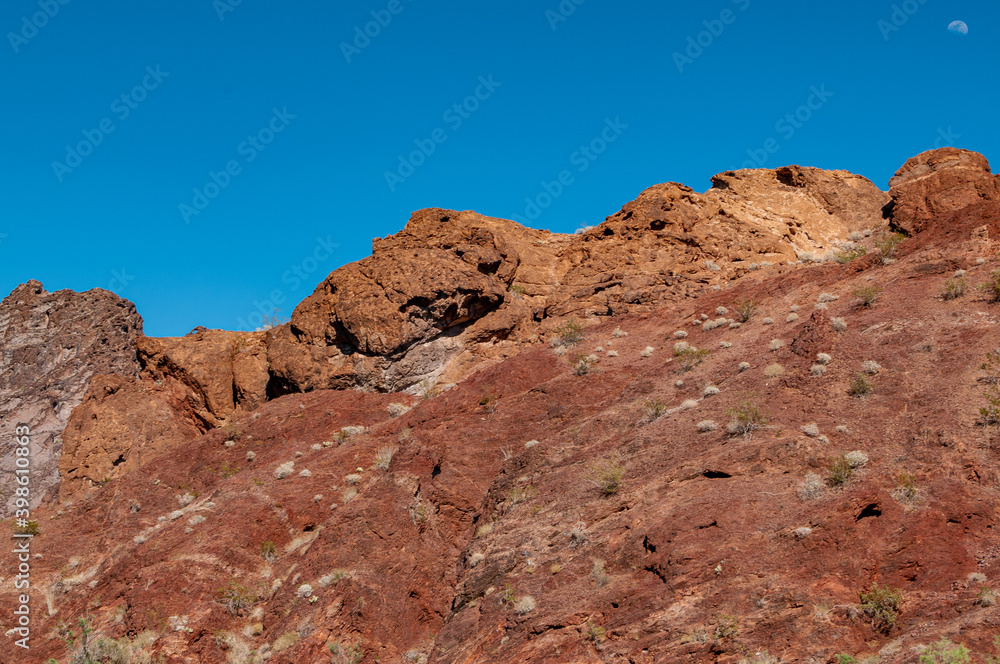 moon over red mountains in the desert